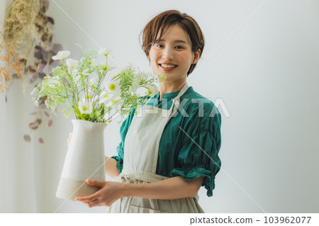 A woman holding a vase A woman holding a vase 103962077