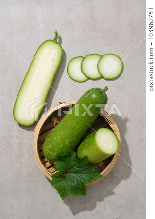 A bamboo steamer containing fresh winter melon inside. Winter melon (Benincasa hispida) is also responsible to produce collagen that repairs tissues, cells, bones 103962751