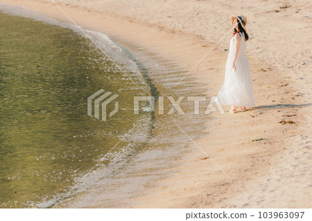 Woman walking with a plastic bottle 103963097