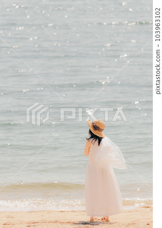 Woman walking with a plastic bottle Woman walking with a plastic bottle 103963102