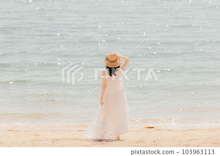 Woman walking with a plastic bottle Woman walking with a plastic bottle 103963113