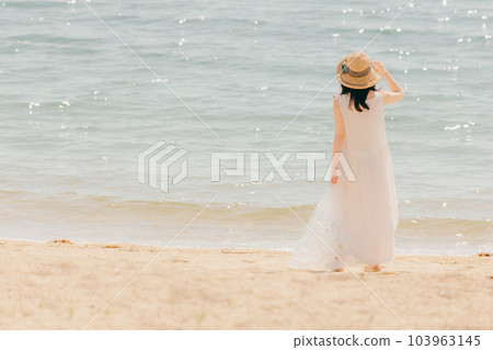 Woman walking with a plastic bottle Woman walking with a plastic bottle 103963145
