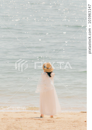 Woman walking with a plastic bottle Woman walking with a plastic bottle 103963147