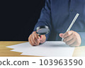 The man creates new idea by magnifying glass and pen. Research and development concept. 103963590