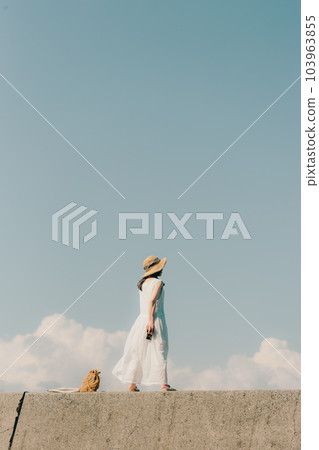Woman sitting with a film camera 103963855
