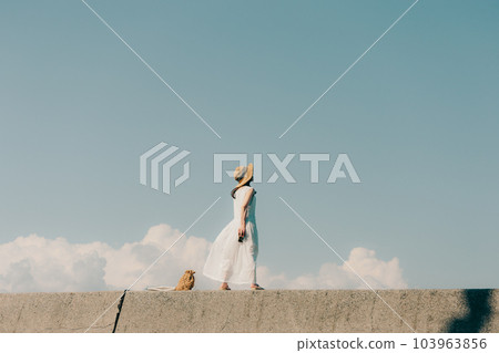 Woman sitting with a film camera 103963856