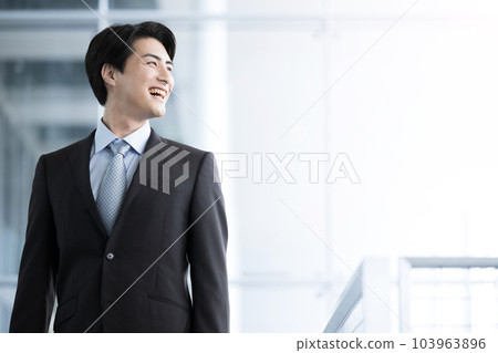 The profile of a handsome male businessman looking up at the image of a recruiter looking up for a job 103963896