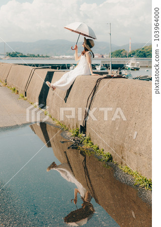woman standing on embankment woman standing on embankment 103964000