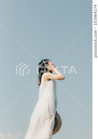 A woman with headphones 103964274