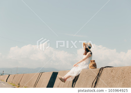 A woman standing in a harbor A woman standing in a harbor 103964925