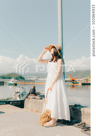 A woman standing in a harbor A woman standing in a harbor 103964935