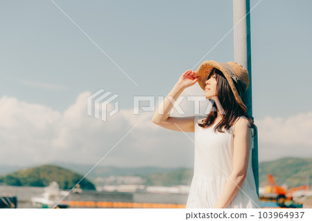 A woman standing in a harbor 103964937