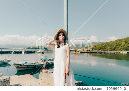 A woman standing in a harbor 103964940