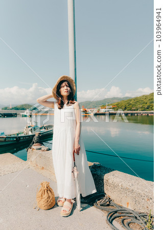 A woman standing in a harbor 103964941