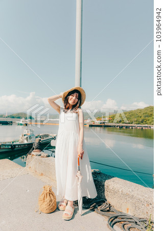A woman standing in a harbor A woman standing in a harbor 103964942