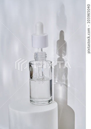 A bottle of serum in water on a white background. 103965040