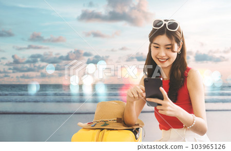 Southeast asian traveler woman using smartphone for travel on summer beach banner size background 103965126