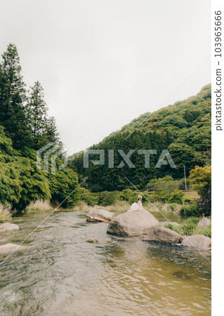 woman standing by the river woman standing by the river 103965666