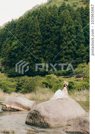 woman standing by the river 103965667