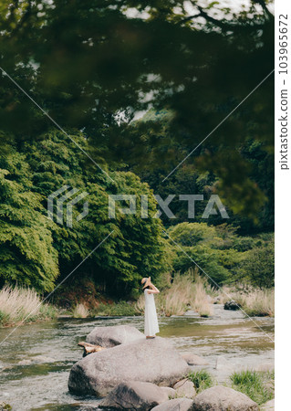 woman standing by the river 103965672