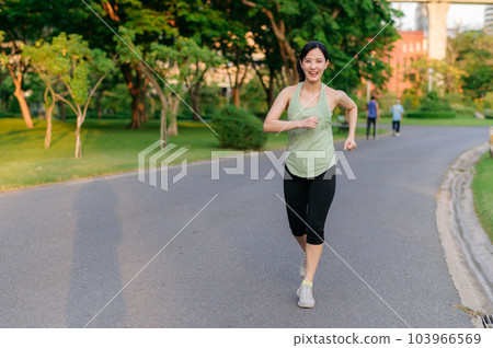 Pretty fitness woman, jogging in the green park Stock Photo by