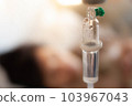 Set vitamin iv fluid intravenous drop saline drip with blur woman lying on bed in hospital room background. Medical Concept treatment emergency and injection drug infusion care chemotherapy concept. 103967043