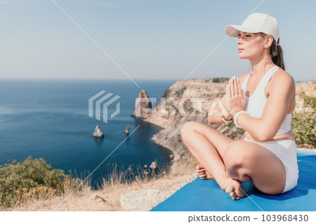 Fitness woman sea. Outdoor workout on yoga mat roller in park near to ocean beach. Female fitness pilates yoga routine concept. Healthy lifestyle. Happy fit woman exercising with rubber band in park. Fitness woman sea. Outdoor workout on yoga mat roller in park near to ocean beach. Female fitness pilates yoga routine concept. Healthy lifestyle. Happy fit woman exercising with rubber band in park. 103968430