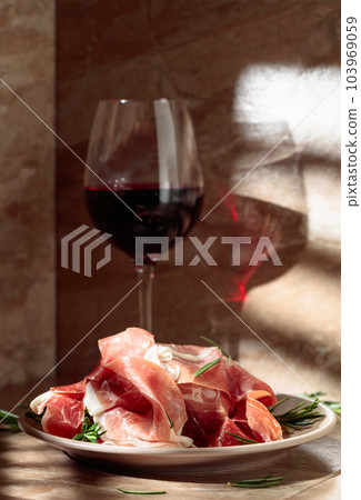Prosciutto or Spanish jamon with rosemary and red wine. Prosciutto or Spanish jamon with rosemary and red wine. 103969059