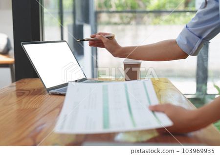 Financier a asian woman works, uses a laptop, makes a report to a finance company. Accounting and financial concept Financier a asian woman works, uses a laptop, makes a report to a finance company. Accounting and financial concept 103969935