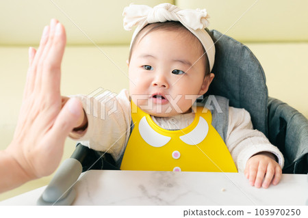 High-five baby Enjoying meal 103970250