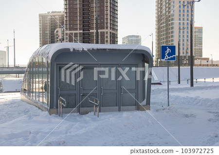Entrance to underpass in city in snow 103972725