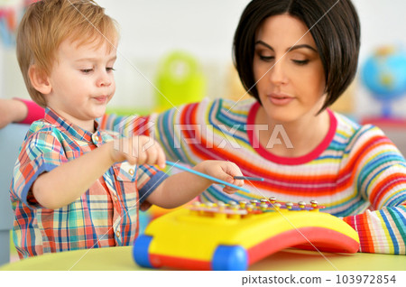 Young mother and cute little son playing 103972854