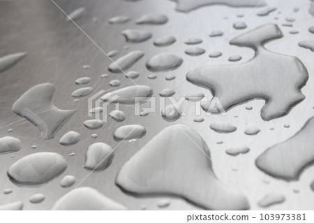 An image of water droplets on a silver iron plate An image of water droplets on a silver iron plate 103973381