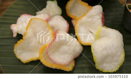 shrimp crisp or prawn chips or traditional fish crackers from asia. Indonesian food called Kerupuk. shrimp crisp or prawn chips or traditional fish crackers from asia. Indonesian food called Kerupuk. 103975310