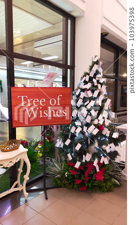 Christmas tree of wish at the corner of public space. People write their wish or resolution and hang it at the tree. Christmas tree of wish at the corner of public space. People write their wish or resolution and hang it at the tree. 103975398