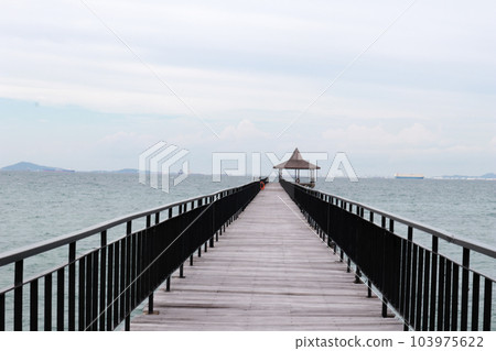 Fishing piers or boardwalk jetty at the seaside or resort very beautiful. Fishing piers or boardwalk jetty at the seaside or resort very beautiful. 103975622