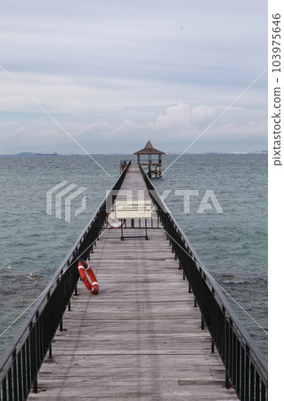 Fishing piers or boardwalk jetty at the seaside or resort being closed at the moment. Fishing piers or boardwalk jetty at the seaside or resort being closed at the moment. 103975646