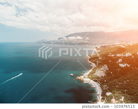 Christian church in the mountains above the sea. Temple of the Holy Archangel Michael in Oreanda. The southern coast of Crimea. Aerial view 103976513