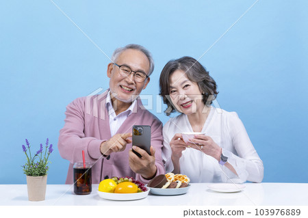 active young senior korean asian couple having teatime active young senior korean asian couple having teatime 103976889