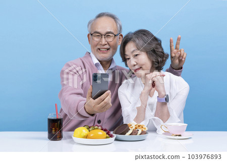 active young senior korean asian couple taking selfies active young senior korean asian couple taking selfies 103976893