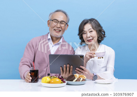active young senior korean asian couple using tablet pc 103976907