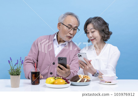 active young senior korean asian couple having teatime 103976912
