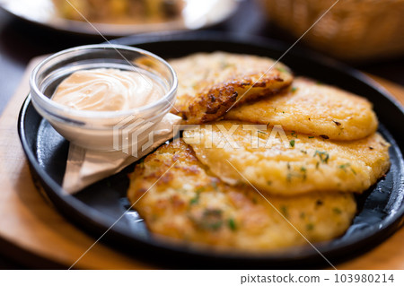Belarusian cuisine. Potato draniki stew with sour cream 103980214