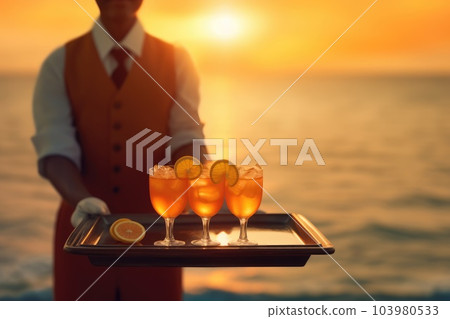 Waiter serving orange juice on a tray, Summer beach sunset holiday vacation. Generative AI Waiter serving orange juice on a tray, Summer beach sunset holiday vacation. Generative AI 103980533