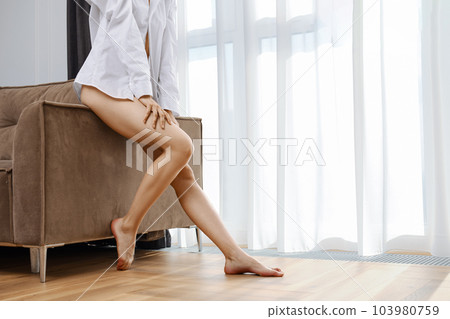 Slender female legs at home closeup Slender female legs at home closeup 103980759