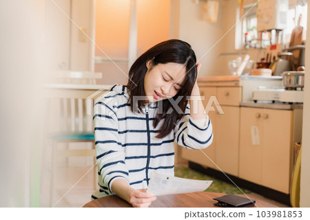 Young woman holding her head over soaring electricity bills Young woman holding her head over soaring electricity bills 103981853