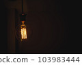 Glowing light bulb in the dark on wall and copy space for text. 103983444
