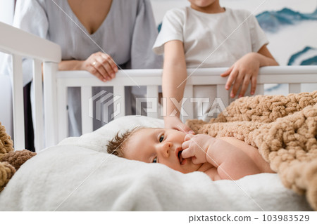 Portrait of infant baby with loved family 103983529