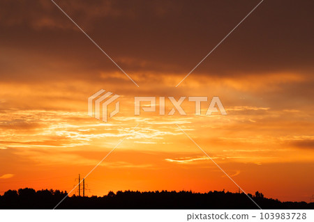 Bright vibrant orange and yellow colors sunset sky Bright vibrant orange and yellow colors sunset sky 103983728