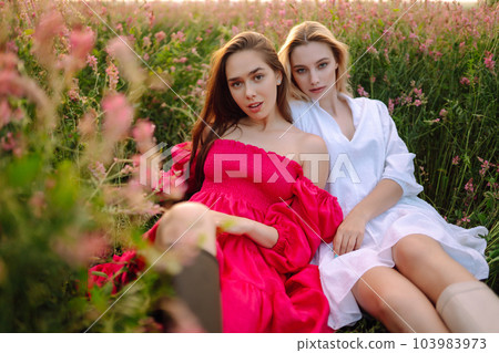 Two Beautiful woman in a field. Nature, fashion, vacation and lifestyle. 103983973